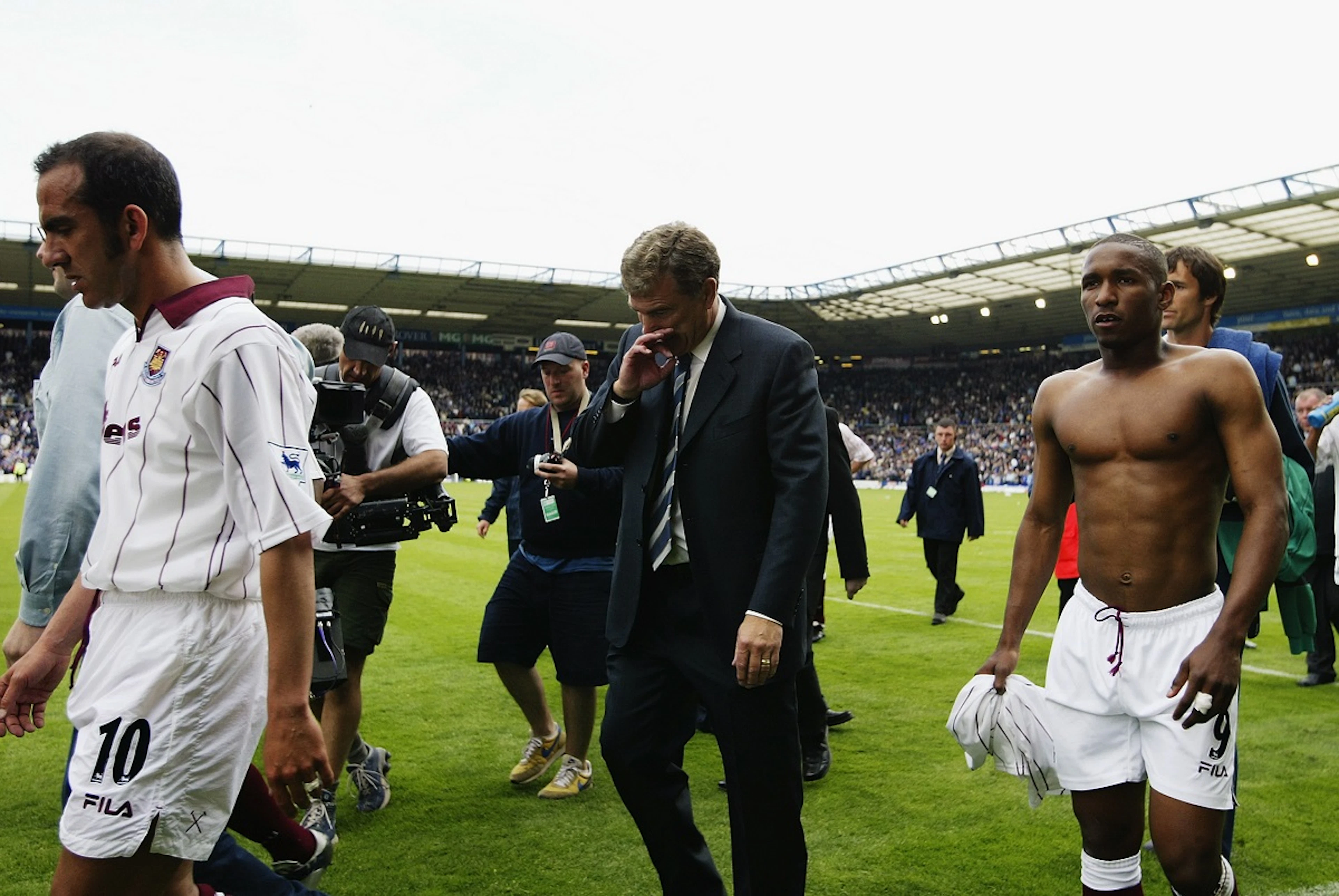 Paulo Di Canio, Trevor Brooking and Jermaine Defoe of West Ham United look dejected as they walk off